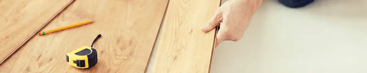 A professional installing wood flooring in Louisville, KY