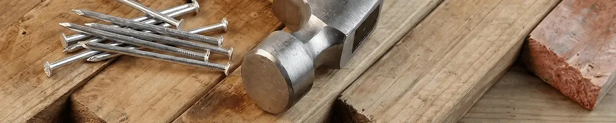 Hammer and nails on hardwood flooring boards in Louisville, KY