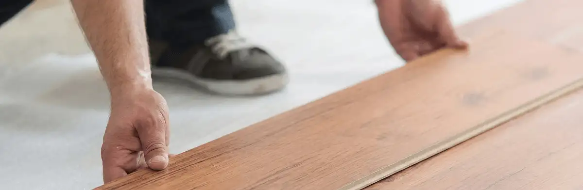 A professional installing laminate flooring in Louisville, KY