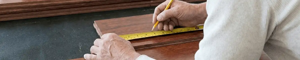 A professional installing wood flooring in Louisville, KY